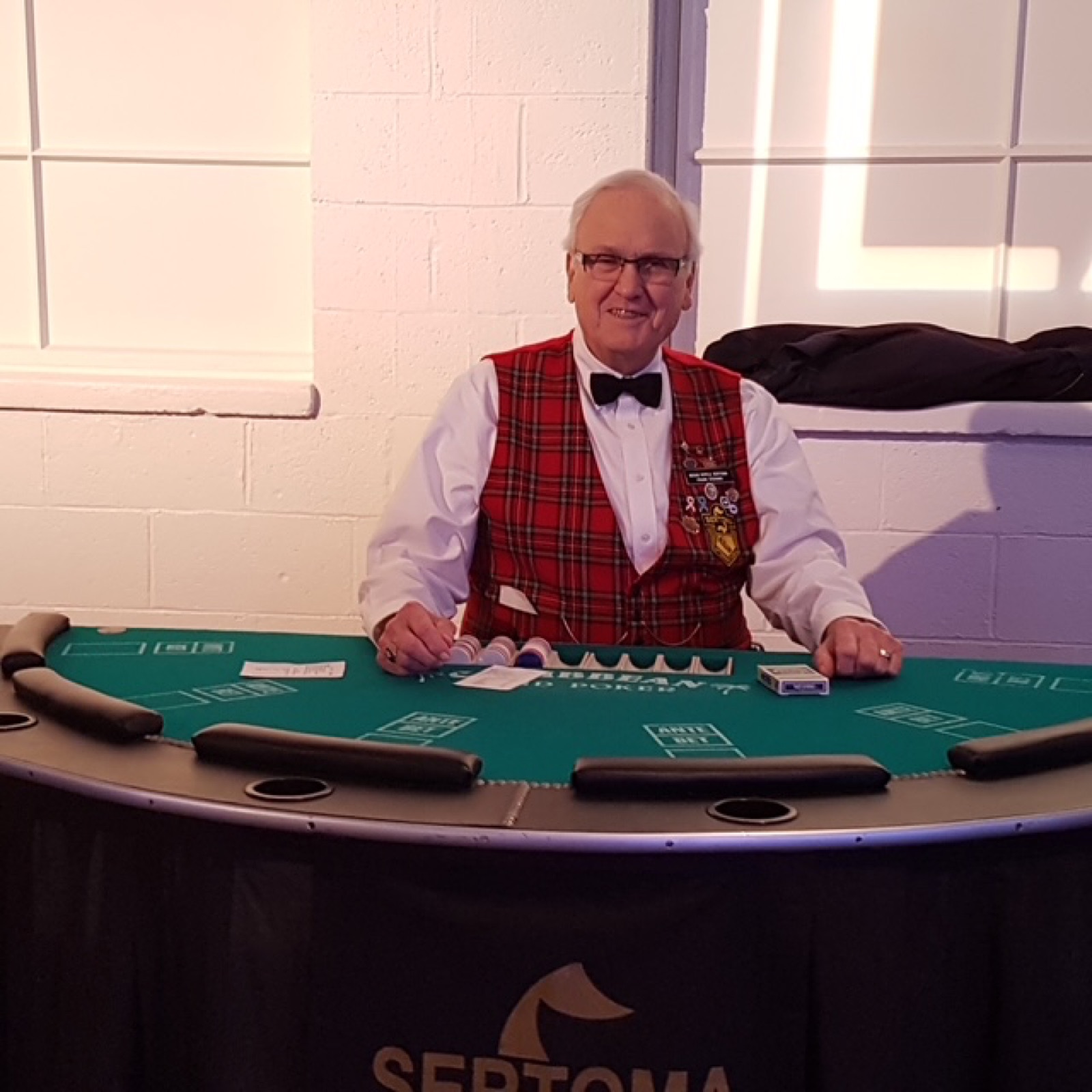 Blackjack dealer smiling at the table