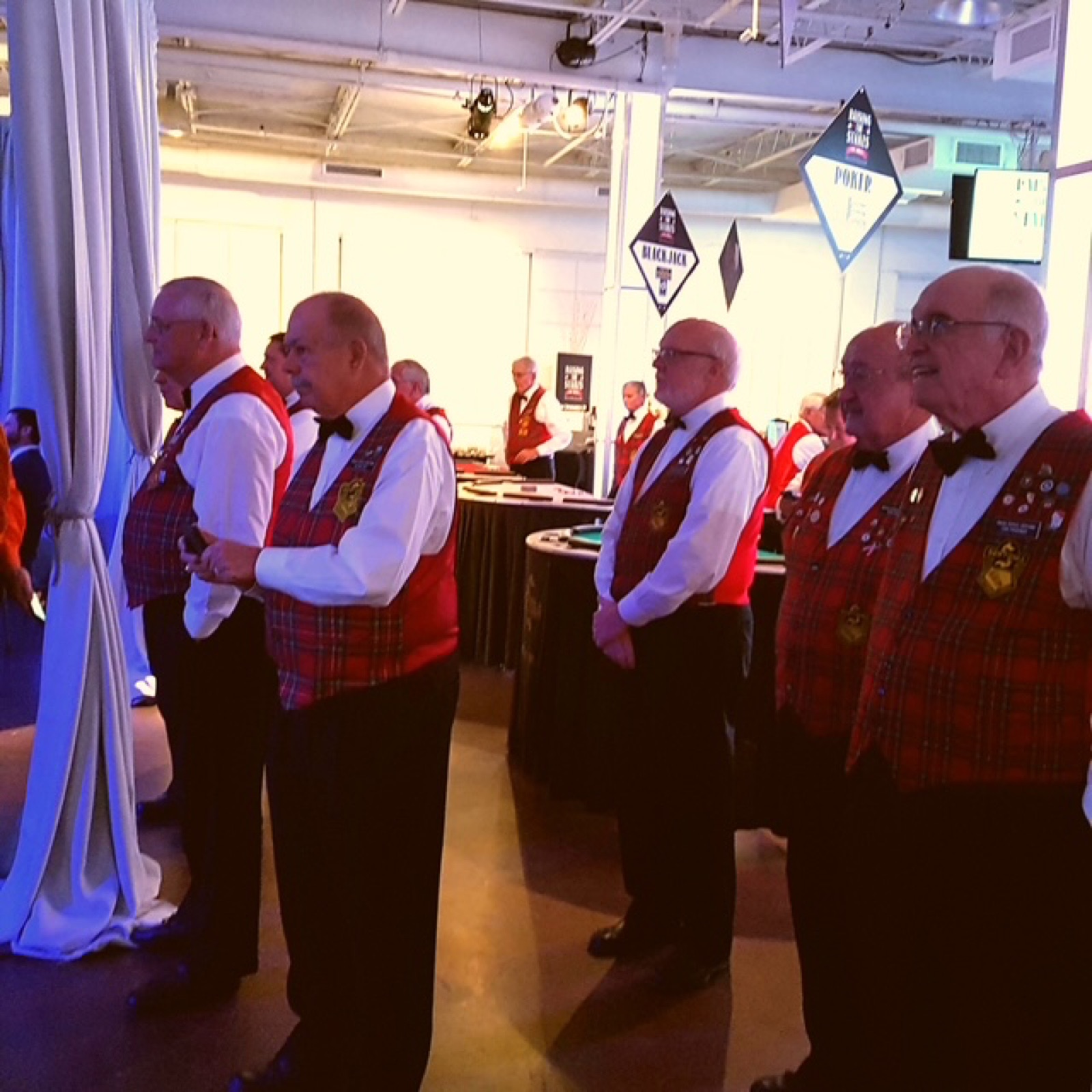 Sertoma volunteers in tartan vests at a charity casino party